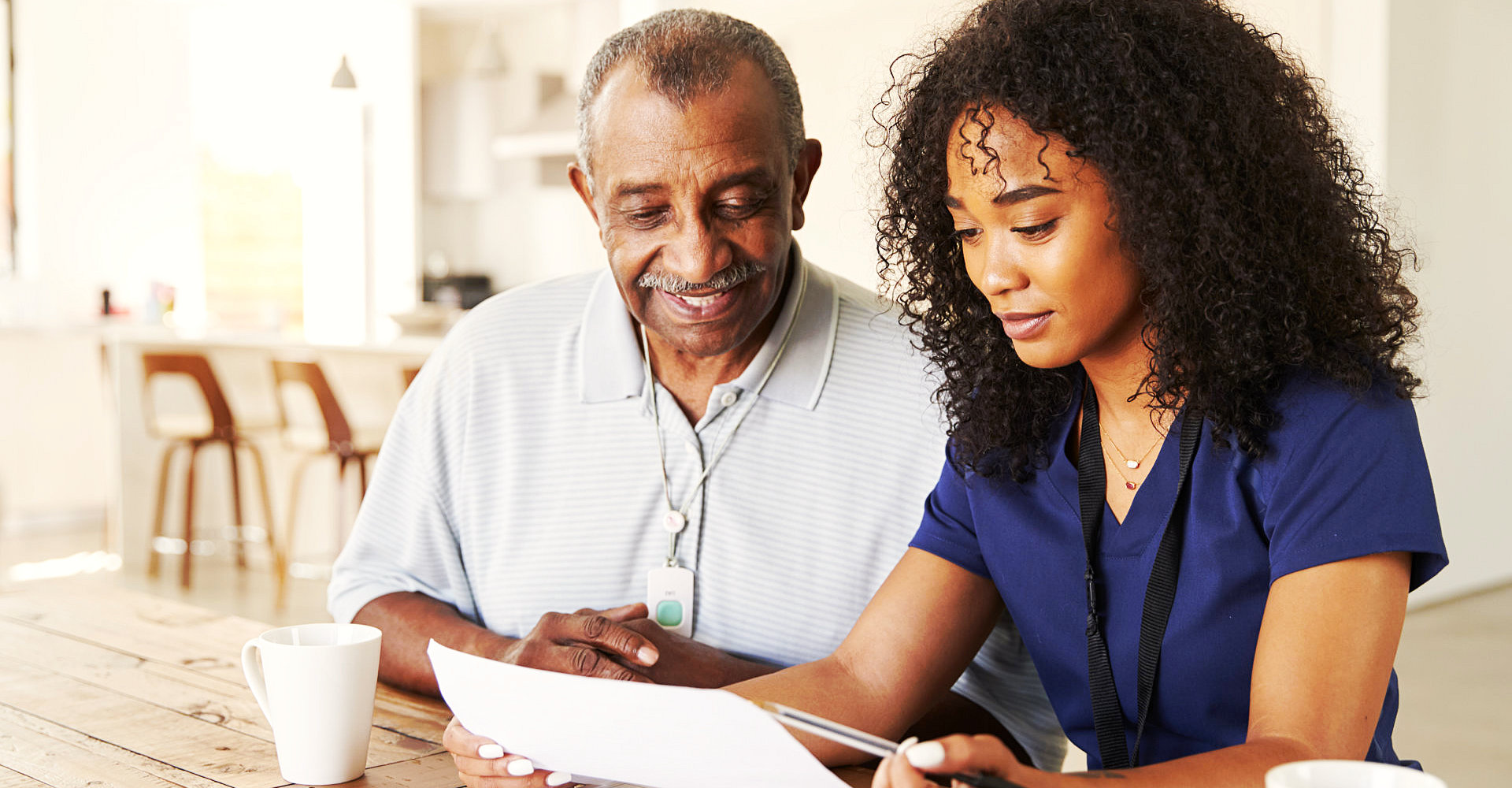 caregiver and senior man smiling