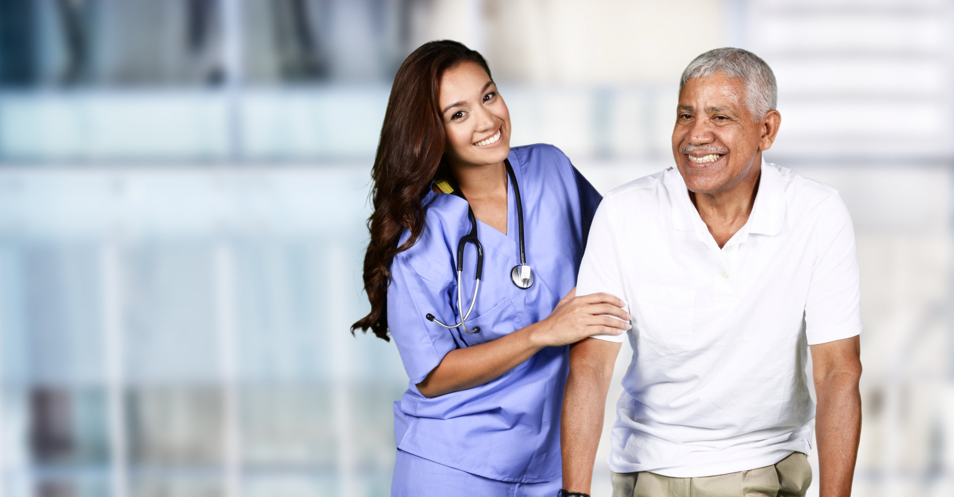 caregiver wearing stethoscopes and senior man smiling