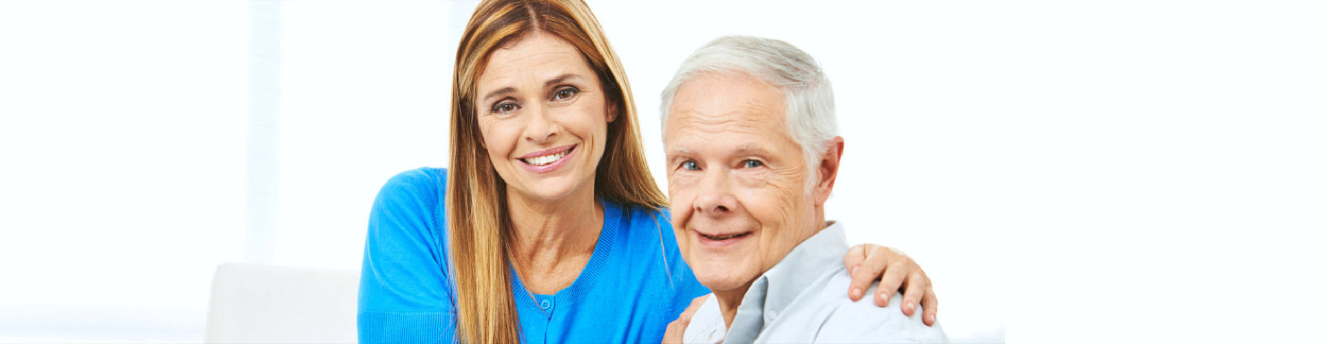 caregiver and senior man smiling